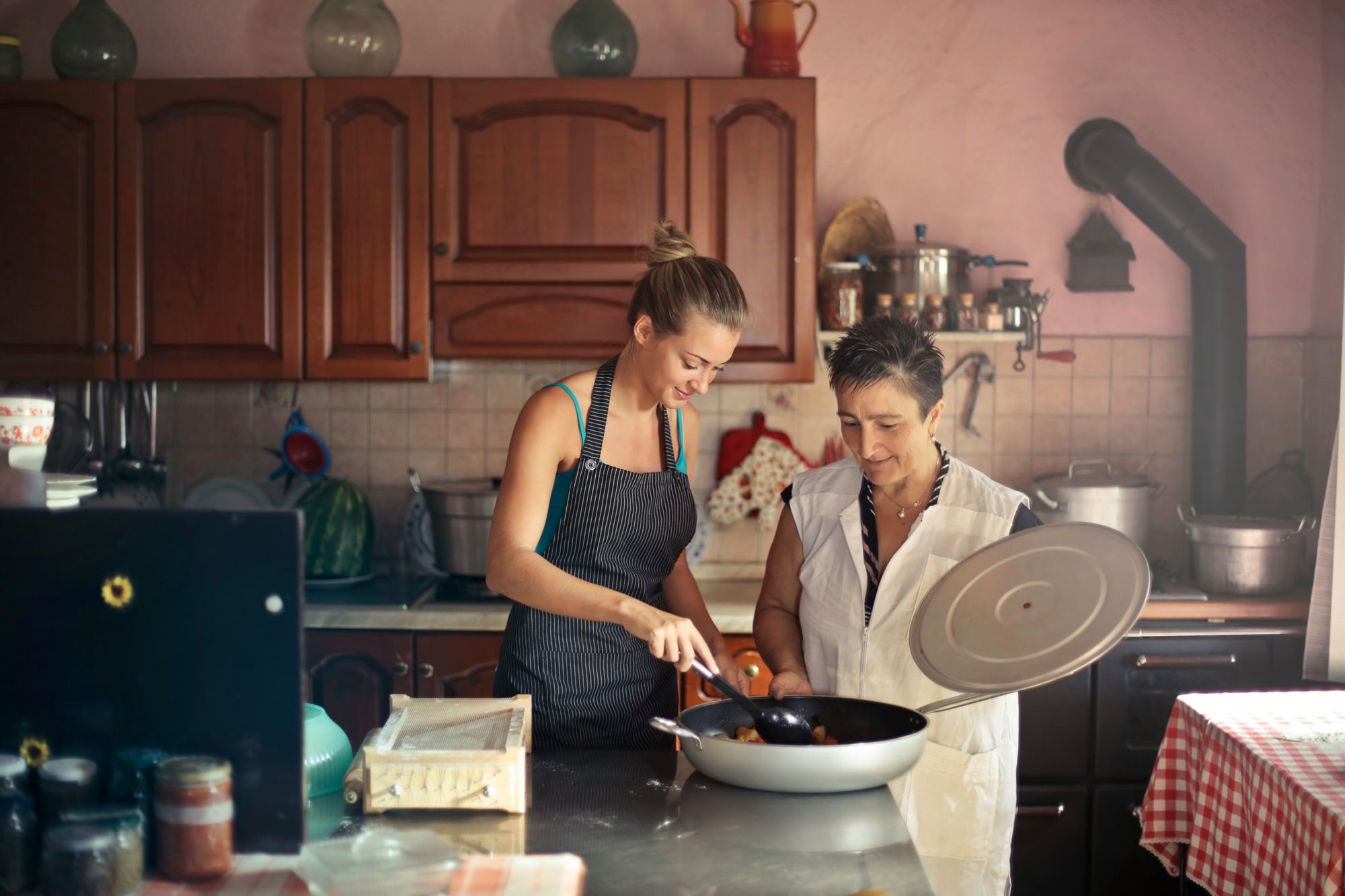 Two women preparing a meal together in a home kitchen